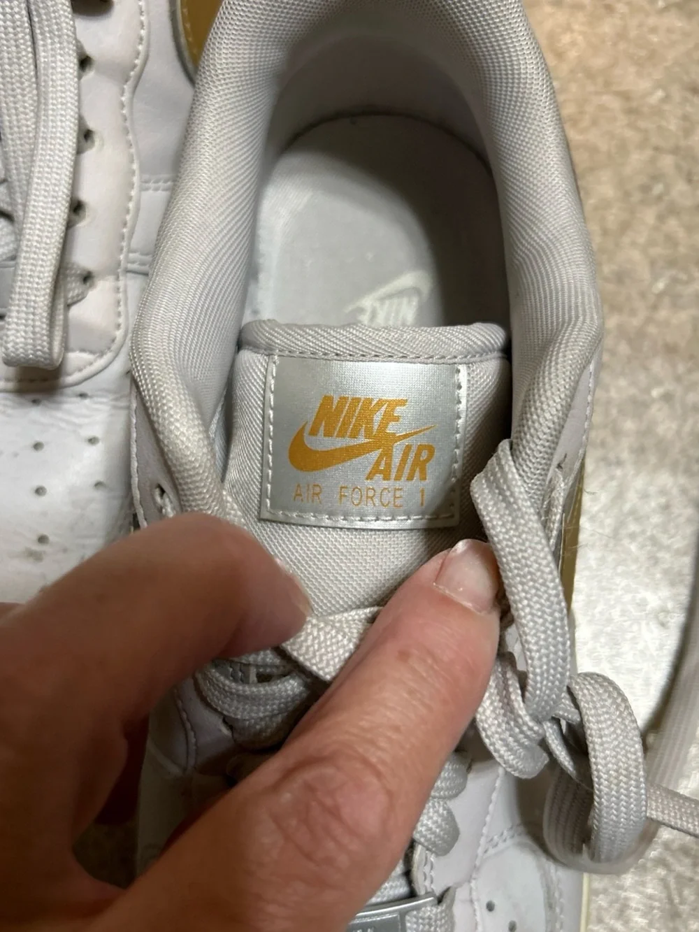 Nike White Athletic Shoes with Gold Swoosh